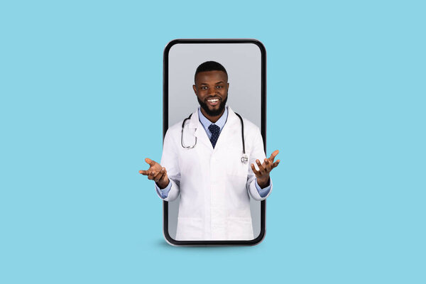 Online Medicine. Smiling Black Doctor Peeking Out Of Big Smartphone Screen