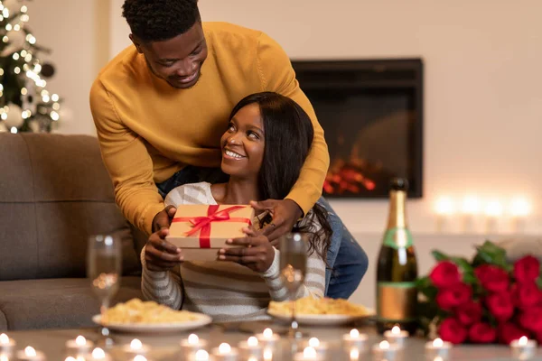 Black Husband Giving Valentine Gift To Wife During Dinner Indoor — Stock fotografie