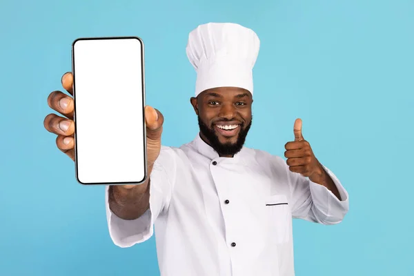 Happy African American Chef Holding Blank Smartphone And Showing Thumb Up — Stock fotografie