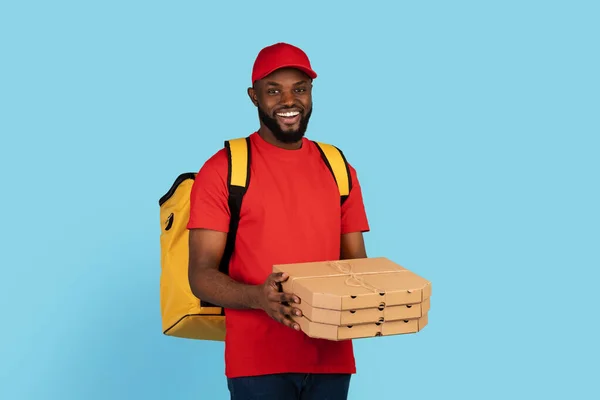 Pizza Delivery. Black Courier Man In Uniform Holding Stack Of Cardboard Boxes — Stock Photo, Image