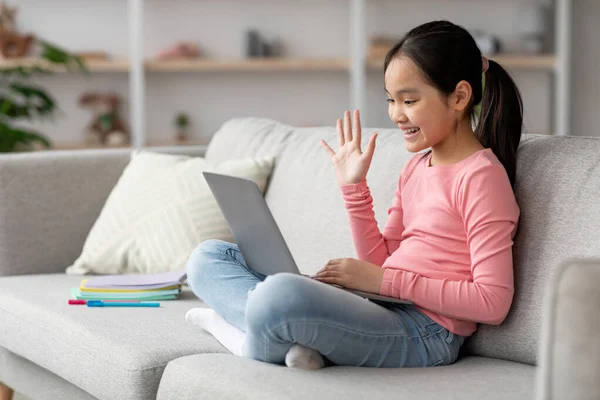 Adorable asian child having video call with friend — Stock Photo, Image