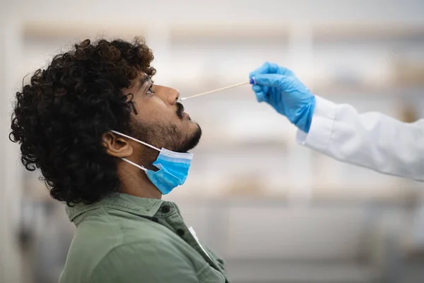 Closeup of indian guy having nasal swab test, COVID-19 diagnostic —  Fotos de Stock