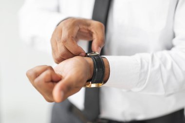 Closeup of African American businessman wearing expensive wrist watch