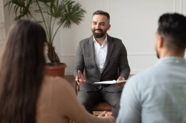 Young couple having therapy session with therapist