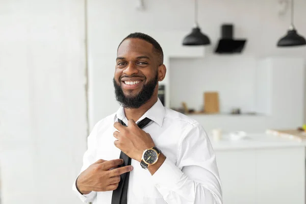 Smiling Confident African American Businessman Adjusting Tie Looking Away — Stockfoto