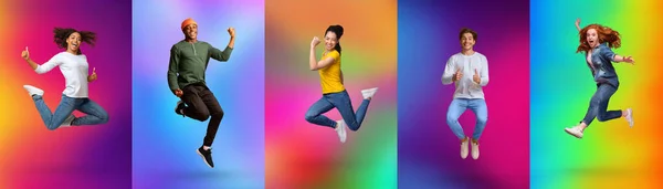 Expressing joy and happiness. Full length of energetic diverse young people jumping over colorful neon backgrounds — Fotografia de Stock