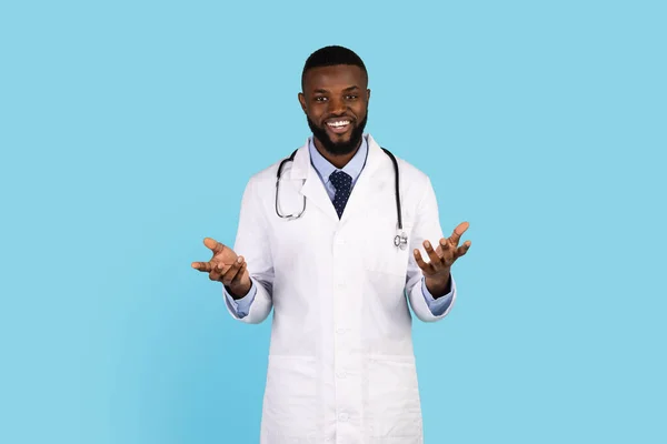 Portrait Of Male African American Doctor In Uniform Posing On Blue Background — Stok fotoğraf