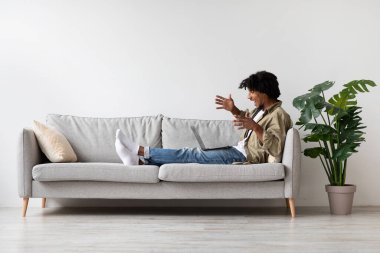 Cheerful young african american man making video call with laptop at home