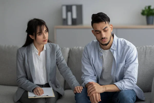 Loneliness, despair and depression concept. Professional psychologist comforting unhappy man, sitting in office — Stock Photo, Image