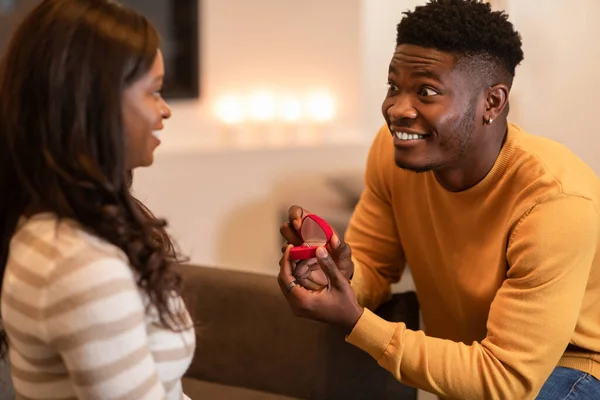 Black Man Proposing Opening Box Showing Woman Engagement Ring Indoor — Stockfoto