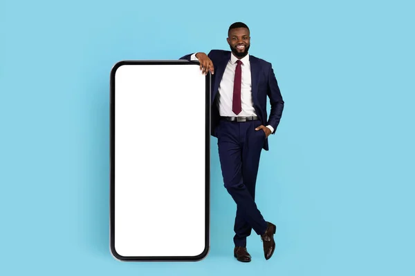 Mobile Offer. Handsome Black Businessman Leaning At Big Blank Mobile Phone — Photo