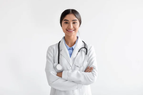 Confiado alegre millennial linda india enfermera en uniforme con los brazos cruzados mirando a la cámara —  Fotos de Stock