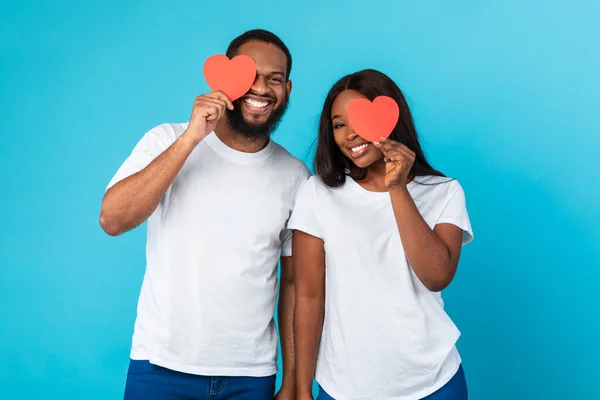Happy Romantic Black Couple Covering Eyes With Red Paper Hearts — Foto Stock