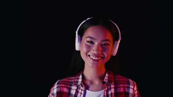 Portrait Of Happy Young Asian Woman Listening Music In Wireless Headphones — Zdjęcie stockowe