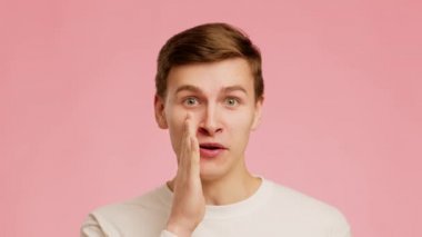 Guy Whispering Holding Hand Near Mouth Sharing Gossips, Pink Background