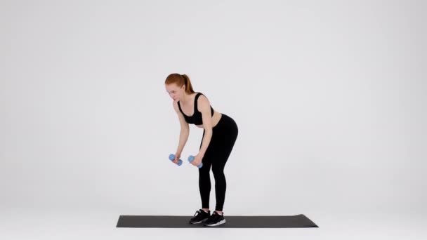 Young Sporty Female Doing Dumbbell Bent Over Fly Exercise In Studio — Vídeos de Stock