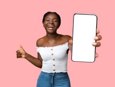 Happy black woman holding smartphone with empty screen
