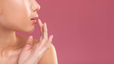 Side view of unrecognizable woman touching her lips