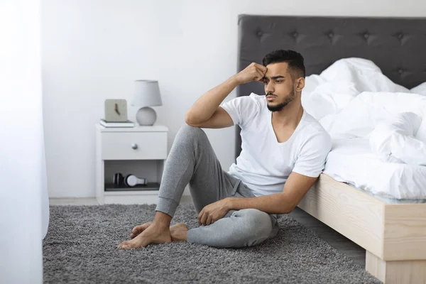 Melancholy Concept. Thoughtful Upset Arab Man Sitting On Floor In Bedroom — Stock fotografie