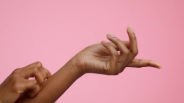 Closeup Of Black Females Hands Scratching Itchy Skin, Pink Background