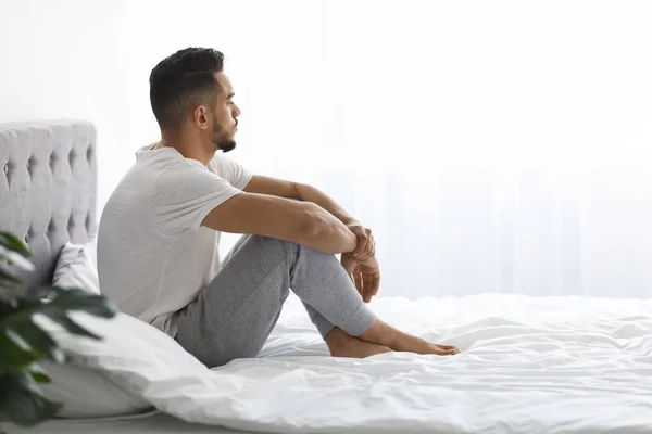 Melancholy. Young Pensive Middle Eastern Man Sitting In Bed And Looking Away — Stock Fotó