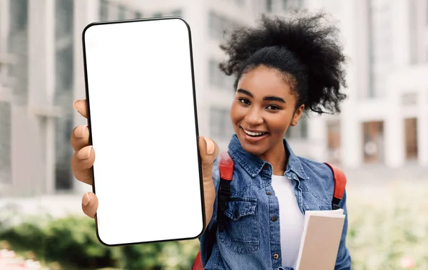 Happy Black Female Student Showing Blank Smartphone While Standing Near University Building — Fotografia de Stock