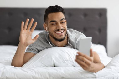 Video Call. Happy Middle Eastern Man Using Smartphone For Online Communication