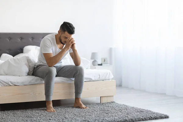 Despair Concept. Portrait Of Depressed Arab Man Sitting On Bed At Home — Foto Stock