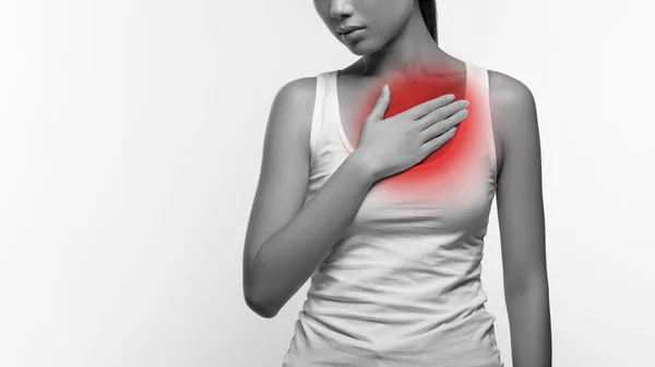 Cropped of female suffering from heartburn or breast pain — Stockfoto