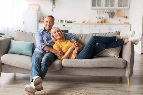 Mature Spouses Hugging Sitting On Sofa Together At Home — Stok fotoğraf