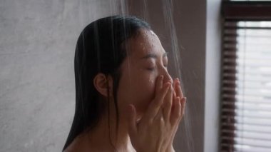 Beautiful Young Asian Woman Standing Under Shower In Bathroom