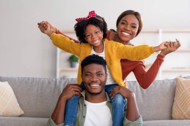 Family Leisure. Happy Black Mom, Dad And Daughter Having Fun At Home
