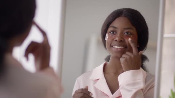 Happy African American Lady Applying Patches Under Eyes At Home — 비디오