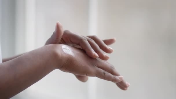 Unrecognizable African American Woman Applying Moisturizer On Hands At Home — Video Stock