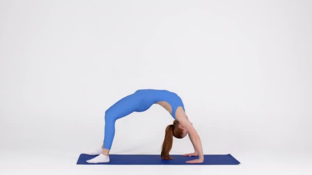 Flexible Young Woman In Sportswear Making Back Bridge Exercise In Studio — Wideo stockowe