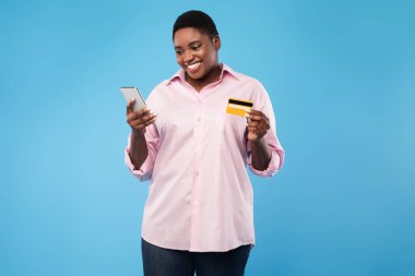 African Lady Holding Phone And Credit Card Shopping, Blue Background