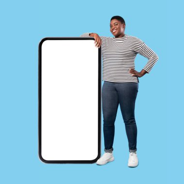 African American Female Leaning On Big Cellphone Screen, Blue Background