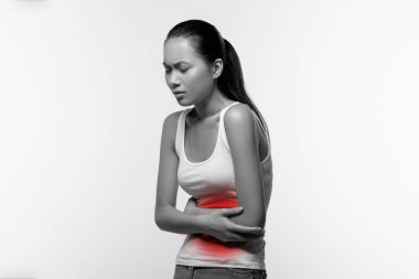Sick woman suffering from abdominal pain, black and white shot