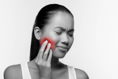 Japanese woman suffering from strong tooth pain, panorama