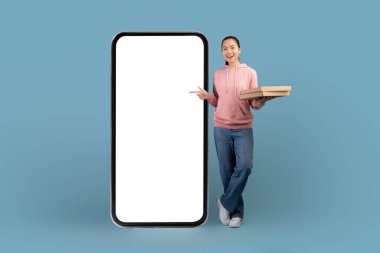 Hungry asian millennial woman order pizza online, using mobile app