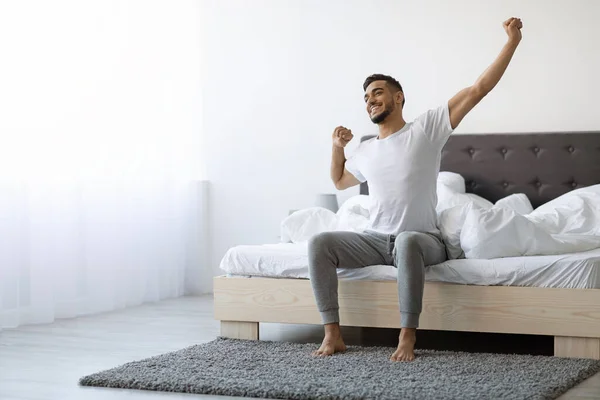 Good Morning. Happy Arab Guy Sitting On Bed And Stretching After Sleep — Foto de Stock