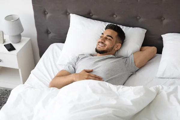 Portrait Of Happy Handsome Middle Eastern Guy Relaxing In Bed At Home — Zdjęcie stockowe