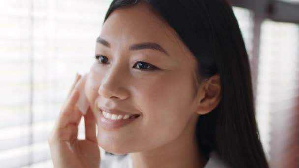 Happy Japanese Woman Using Cotton Pad Cleansing Skin In Bathroom — Vídeo de Stock