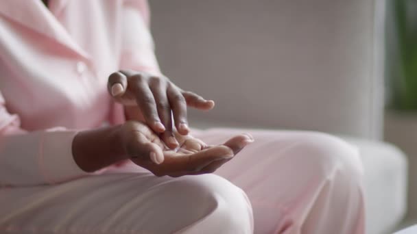 Unrecognizable African American Woman Moisturizing Hands, Applying Cream Indoor, Cropped — Vídeos de Stock