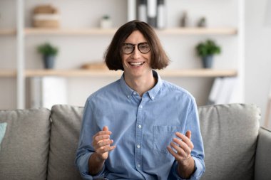 Online communication and internet meeting concept. Happy young guy calling his friend on webcam