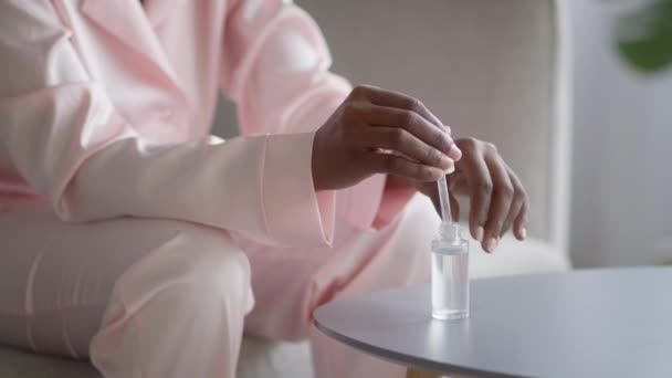 African Woman Applying Serum On Hand Moisturizing Skin Indoor, Cropped — Stockvideo