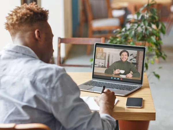 Webinar. Young Black Guy Taking Notes During Video Conference With Male Teacher — Stock Photo, Image