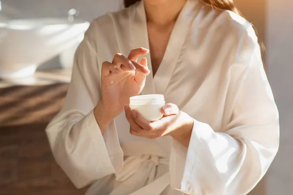 Female hands holding beauty care product, closeup —  Fotos de Stock