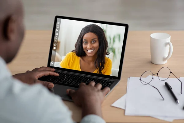 Middle-aged man having video call with pretty black lady — Stock Photo, Image