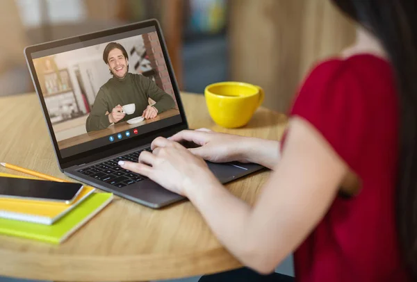 Female freelancer having videocall with boyfriend while working with laptop in cafe — Stock Photo, Image